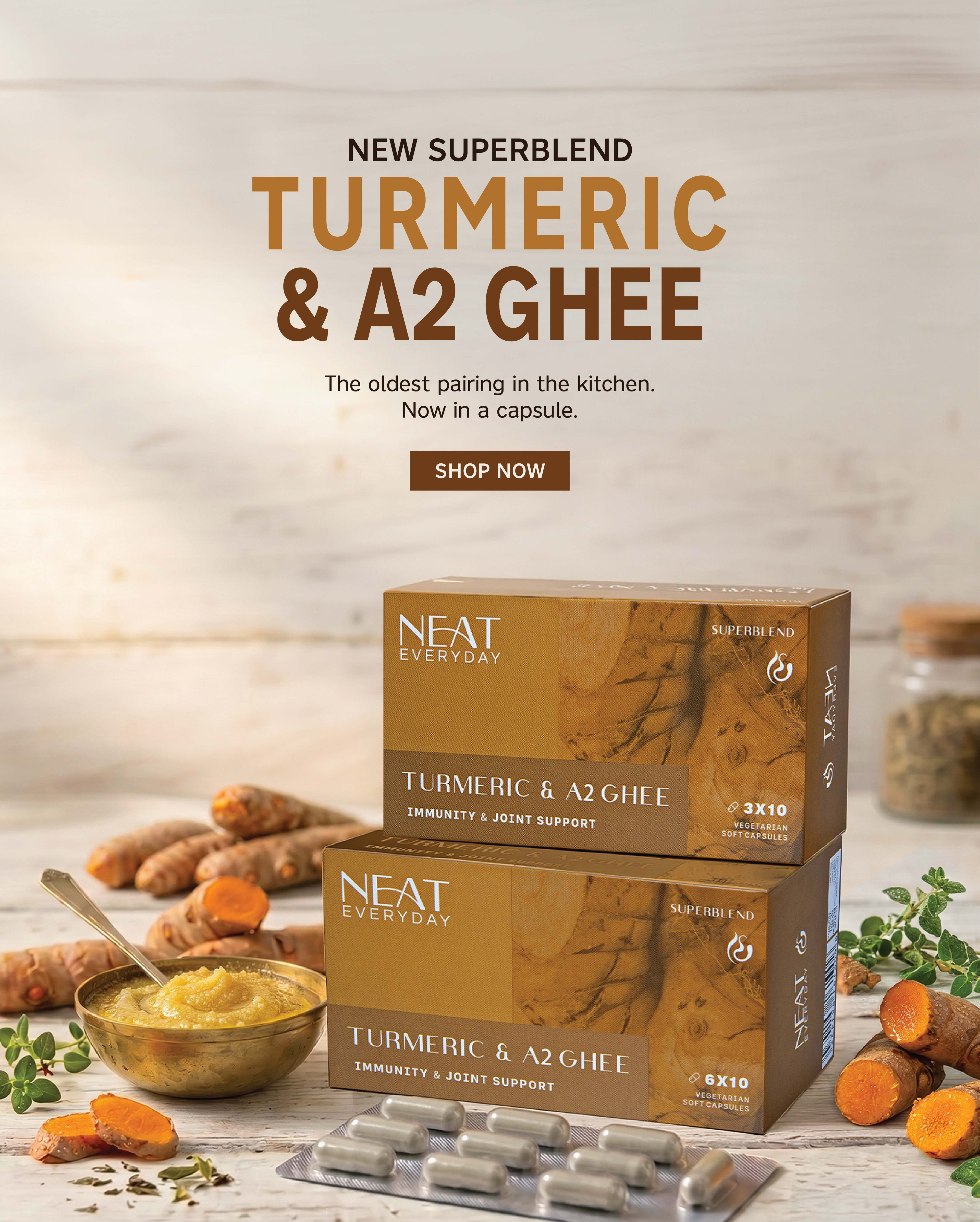 Neat Everyday Turmeric & A2 Ghee supplement packaging with turmeric roots and ghee on a wooden surface.