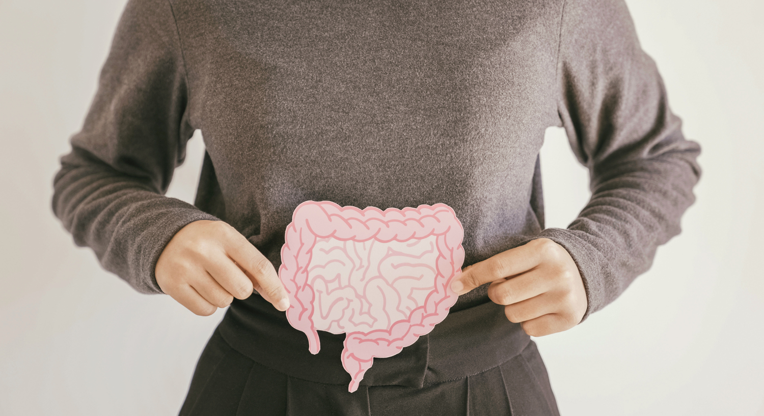Woman holding illustration of intestines to promote gut health awareness
