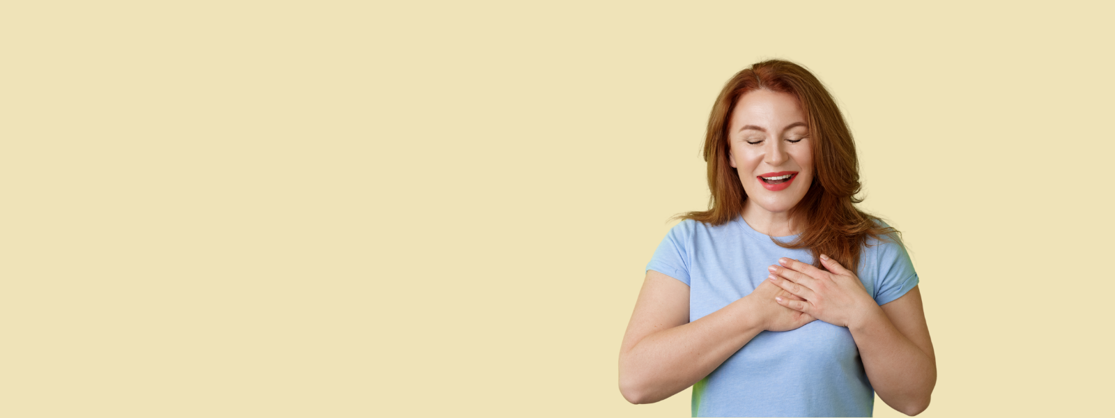 Woman smiling with hands on heart symbolizing flaxseed oil benefits.