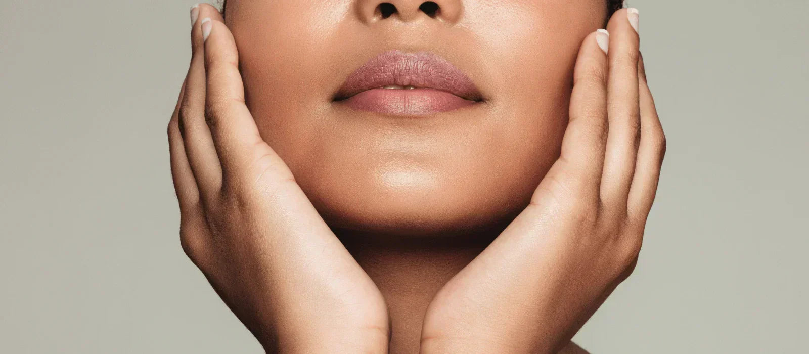 Woman with glowing skin showcasing natural skincare results.