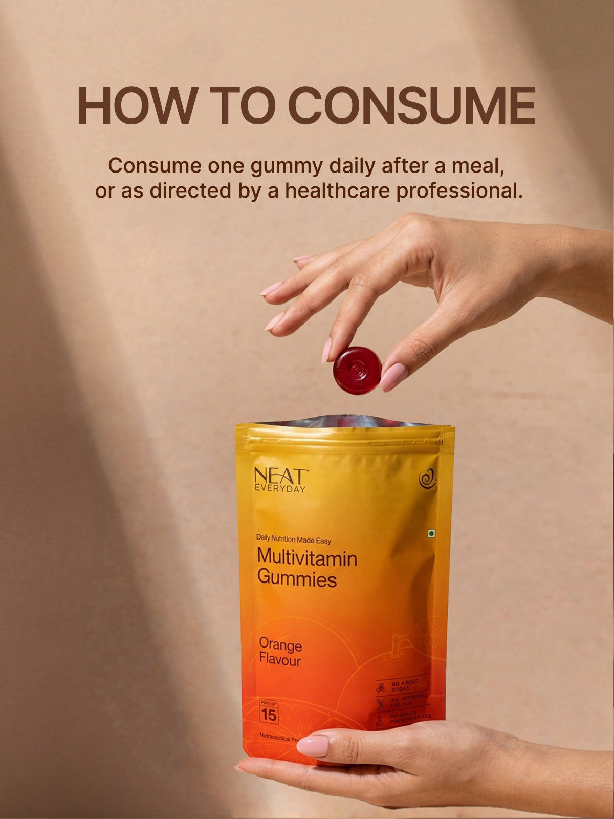 Multivitamin gummies packaging with a hand holding a gummy and text on a beige background