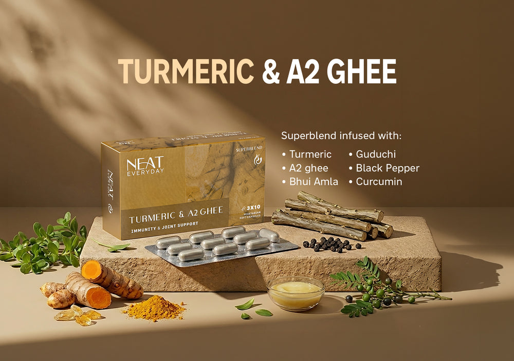 Turmeric and A2 Ghee supplement packaging with ingredients on a stone surface.