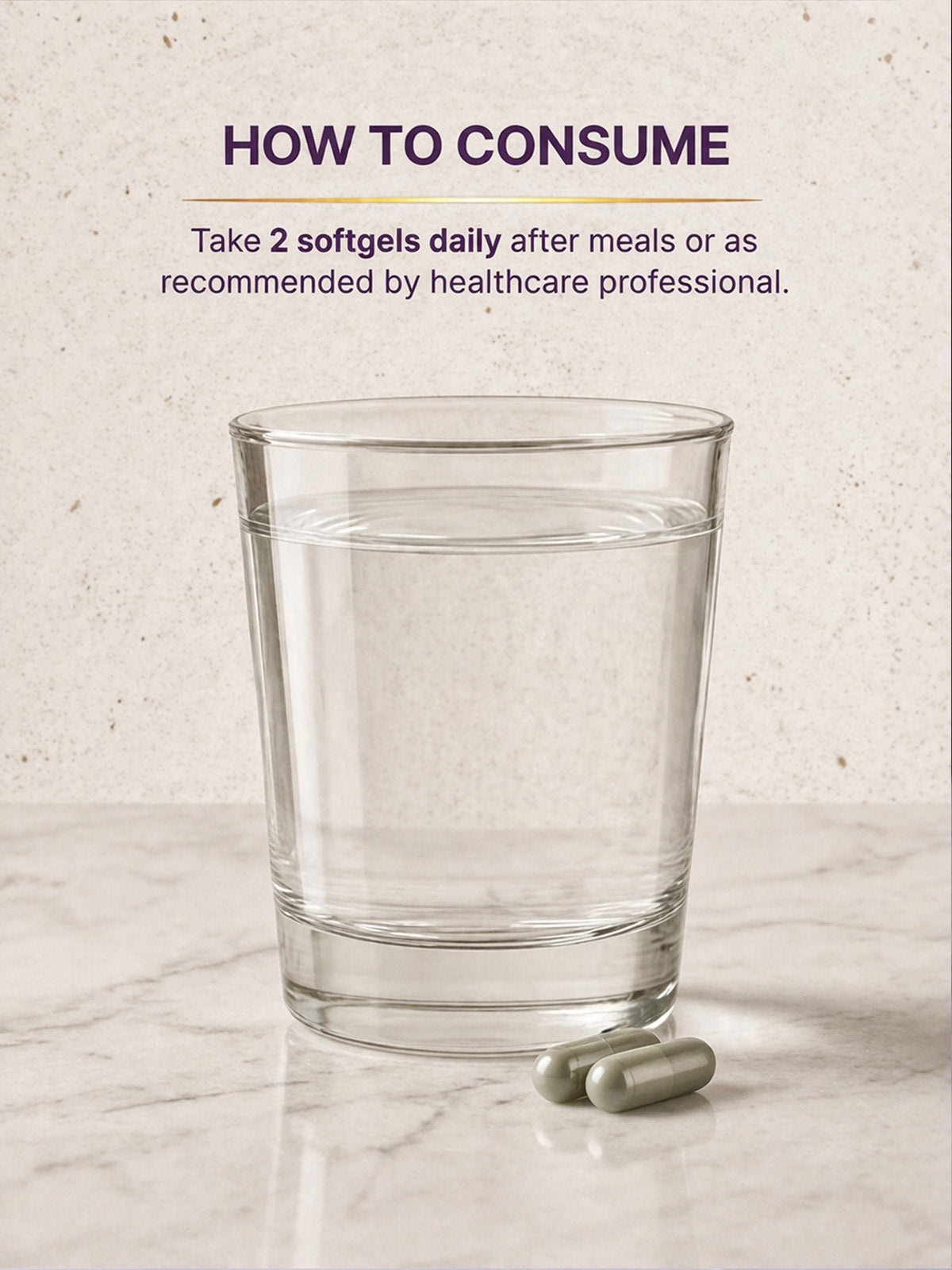 Glass of water with two softgels on a marble surface, with text on how to consume.