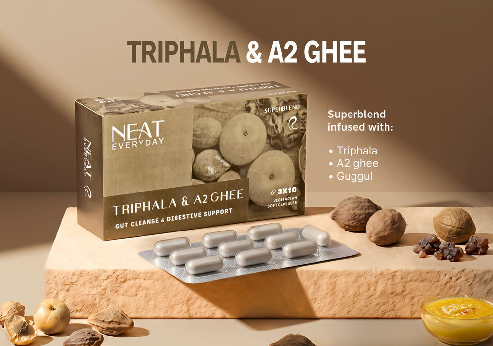 NEAT Triphala & A2 Ghee supplement packaging with capsules on a neutral background