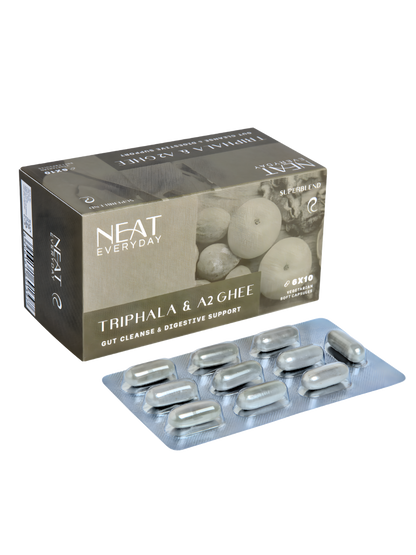 Packaging of NEAT Everyday Triphala &amp; A2 Ghee capsules on a white background