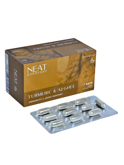 Box of Neat Everyday Turmeric &amp; A2 Ghee supplements with capsules on a white background